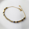 Złota bransoletka z czarnymi kulkami - pr.585